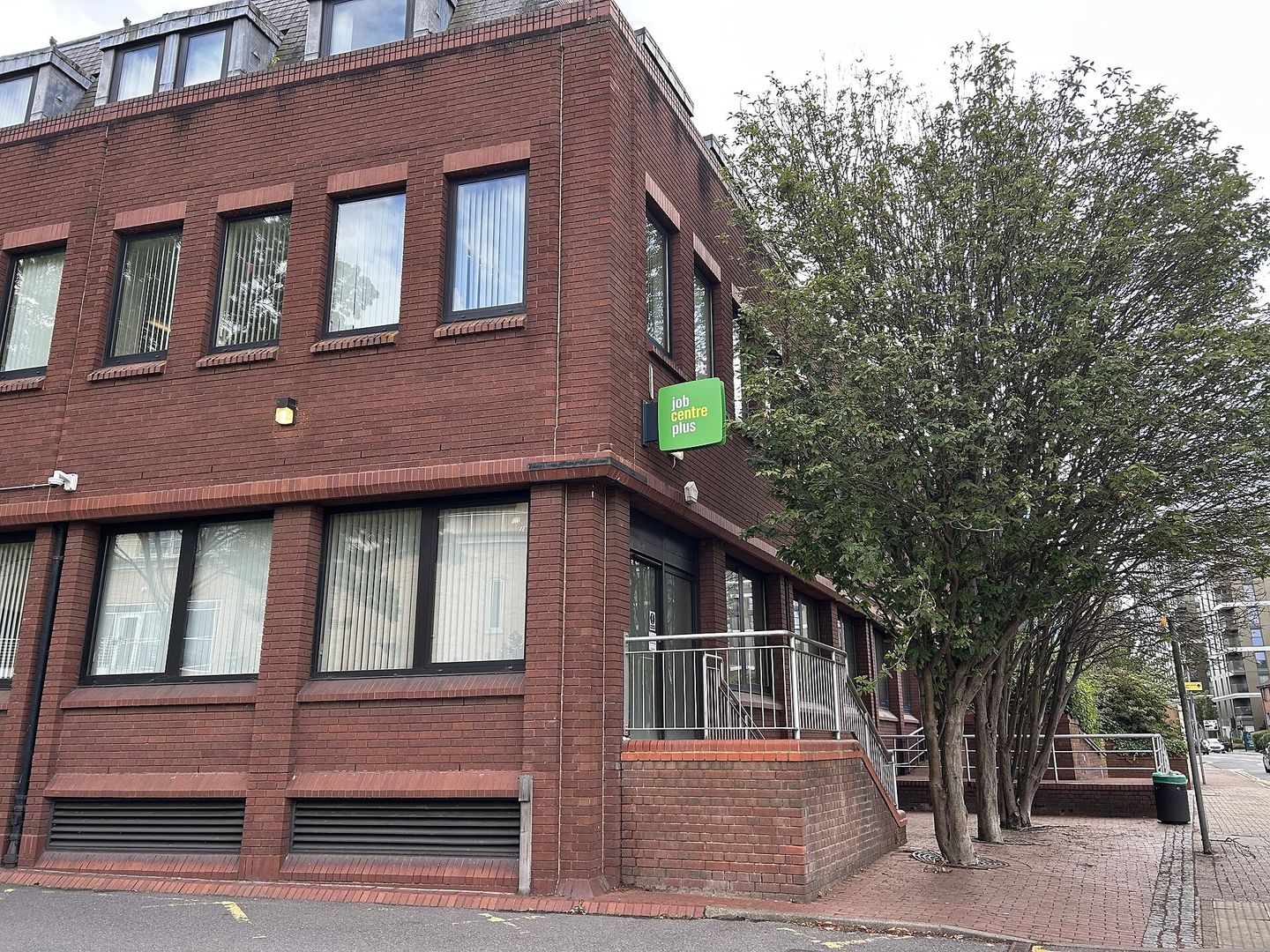 A Jobcentre Plus office in a red-brick building, its sign above the door.