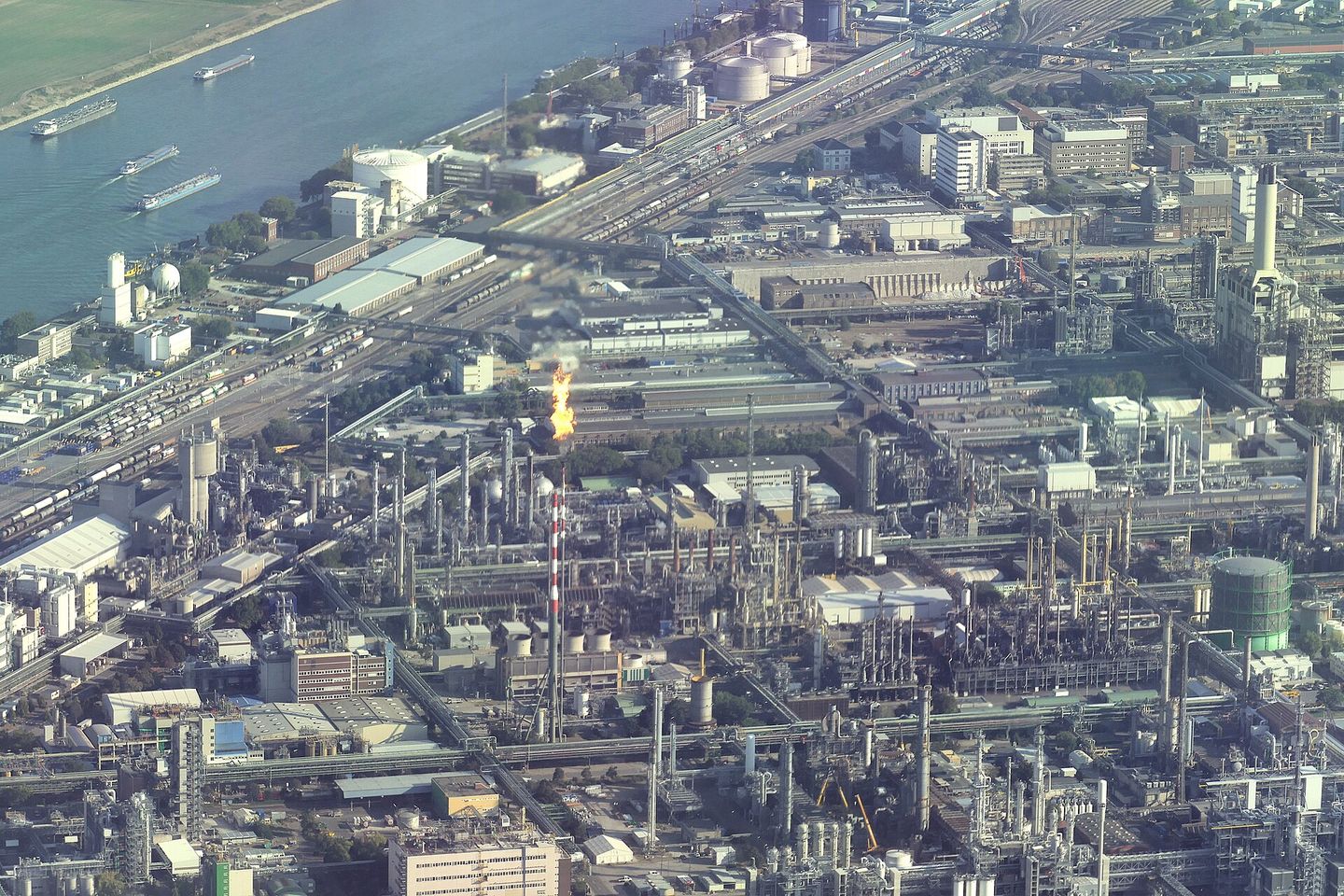 An aerial view of the BASF chemical works at Ludwigshafen on the Rhine, a flare burning at its centre.